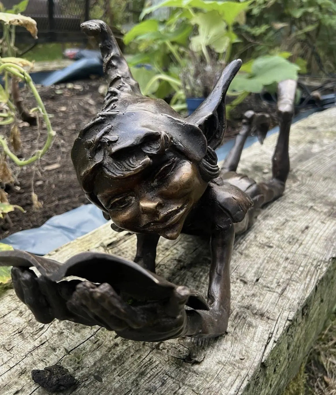 Bronze laying pixie reading