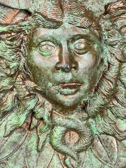 Bronze colour cast aluminium roundel wall decoration