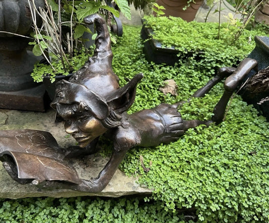 Bronze laying pixie reading