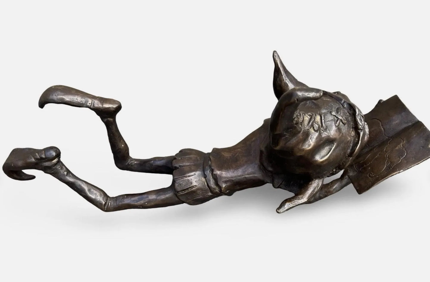 Bronze laying pixie reading