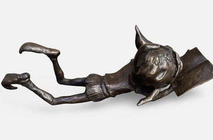 Bronze laying pixie reading